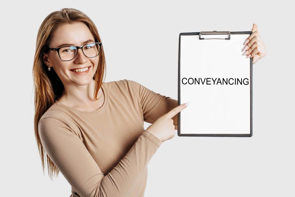 Conveyancing.,Beautiful,Young,Business,Woman,Wearing,Glasses,Holds,A,Clipboard