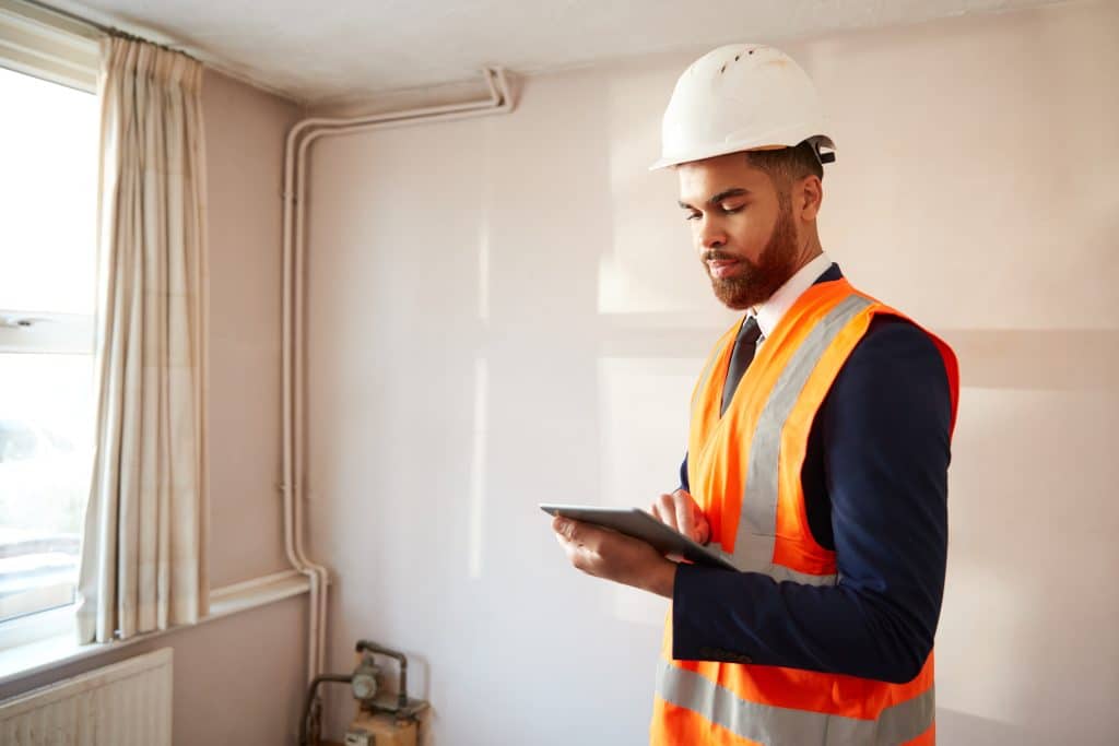 Surveyor,In,Hard,Hat,And,High,Visibility,Jacket,With,Digital